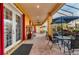 Outdoor patio with ample seating area, a sunroom, and red curtains for added elegance at 3020 Crews Lake Dr, Lakeland, FL 33813