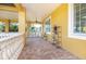 Covered patio with a seating area, a ceiling fan, and views of the surrounding landscape at 3020 Crews Lake Dr, Lakeland, FL 33813