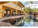 Outdoor pool with lounge chairs, dining tables, umbrellas, and views of the building's exterior at 3020 Crews Lake Dr, Lakeland, FL 33813
