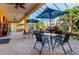 Relaxing pool area featuring lush tropical landscaping, a rock waterfall, and a covered dining space, perfect for entertaining at 3020 Crews Lake Dr, Lakeland, FL 33813