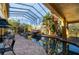 Indoor pool featuring lush tropical landscaping, a rock waterfall, and an enclosed glass ceiling, creating a serene oasis at 3020 Crews Lake Dr, Lakeland, FL 33813