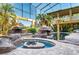 Outdoor pool area featuring unique rock structures and palm trees, providing a tropical oasis at 3020 Crews Lake Dr, Lakeland, FL 33813