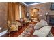 Cozy sitting area boasts rich colors, hardwood floors, and a fireplace, perfect for relaxing and entertaining guests at 3020 Crews Lake Dr, Lakeland, FL 33813