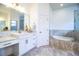 Large bathroom featuring double vanity, soaking tub, walk-in shower, and neutral finishes at 3176 Pearly Dr, Lakeland, FL 33812