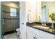 Modern bathroom with glass shower, granite vanity and neutral tile flooring at 3176 Pearly Dr, Lakeland, FL 33812