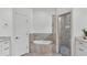 Luxurious bathroom featuring a soaking tub, glass-enclosed shower, and stylish marble countertops at 3176 Pearly Dr, Lakeland, FL 33812