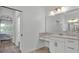Modern bathroom featuring a marble countertop vanity with a doorway leading into the bedroom at 3176 Pearly Dr, Lakeland, FL 33812