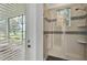 Shower featuring decorative tile detail and seamless glass door at 3176 Pearly Dr, Lakeland, FL 33812