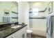 Bright bathroom featuring tub, shower and large vanity with black granite countertop at 3176 Pearly Dr, Lakeland, FL 33812