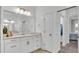 Bright bathroom with marble countertop vanity and an adjacent doorway to a walk-in closet at 3176 Pearly Dr, Lakeland, FL 33812