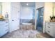 Luxurious bathroom featuring a soaking tub, glass enclosed shower and double vanity at 3176 Pearly Dr, Lakeland, FL 33812