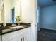 Bright bathroom with modern granite vanity and view to the bedroom at 3176 Pearly Dr, Lakeland, FL 33812