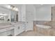 Light filled bathroom features a soaking tub, tile accents, and vanity space at 3176 Pearly Dr, Lakeland, FL 33812