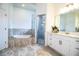 Spacious bathroom with marble countertops, double vanity, a soaking tub and a walk-in shower at 3176 Pearly Dr, Lakeland, FL 33812