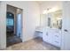 Bright bathroom featuring marble countertops, tile floors, and a makeup vanity area at 3176 Pearly Dr, Lakeland, FL 33812