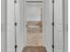 View through double doors to an elegant bathroom with a soaking tub and marble floors at 3176 Pearly Dr, Lakeland, FL 33812