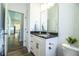 Bright bathroom with modern fixtures, granite vanity and view to the kitchen and home beyond at 3176 Pearly Dr, Lakeland, FL 33812