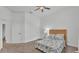 Bright bedroom featuring a ceiling fan, carpet floors and a comfortable bed with floral bedding at 3176 Pearly Dr, Lakeland, FL 33812