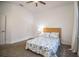 Cozy bedroom featuring neutral walls and carpet plus a queen size bed with floral patterned comforter at 3176 Pearly Dr, Lakeland, FL 33812