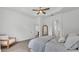 Neutral bedroom with soft carpet, tray ceiling, chair, and ensuite bathroom with mirror at 3176 Pearly Dr, Lakeland, FL 33812