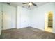 Large bedroom with ceiling fan, carpet, spacious closet and access to the bathroom at 3176 Pearly Dr, Lakeland, FL 33812