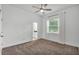 Bright bedroom featuring carpeted floors, a ceiling fan and a large window at 3176 Pearly Dr, Lakeland, FL 33812