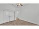 Neutral bedroom featuring neutral carpet, a ceiling fan, and a double door closet at 3176 Pearly Dr, Lakeland, FL 33812