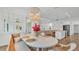 Bright dining area with a rattan-backed bench, oval table, and view of the kitchen and living room at 3176 Pearly Dr, Lakeland, FL 33812