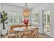 Cozy dining area is brightly lit by a large window and features rattan chairs and light fixture at 3176 Pearly Dr, Lakeland, FL 33812