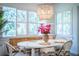 Bright dining room with shutters, decorative chandelier, and seating for four at 3176 Pearly Dr, Lakeland, FL 33812