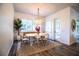 This dining room is filled with natural light and features an elegant chandelier and seating for four at 3176 Pearly Dr, Lakeland, FL 33812