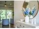 Stylish entryway with console table, mirror, decorative accessories, and wood flooring at 3176 Pearly Dr, Lakeland, FL 33812