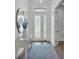 Elegant entryway with decorative glass door, modern light fixture, and stylish mirror at 3176 Pearly Dr, Lakeland, FL 33812