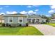 Beautiful home featuring a large three-car garage, well-kept lawn, and elegant brick driveway at 3176 Pearly Dr, Lakeland, FL 33812