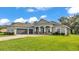 Lovely house with a three-car garage, lush lawn, and attractive brick-paved driveway at 3176 Pearly Dr, Lakeland, FL 33812