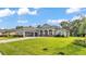 Inviting single-story home with three car garage, lush lawn, and brick paver driveway at 3176 Pearly Dr, Lakeland, FL 33812
