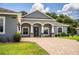 Inviting front entrance with stone accents, lush landscaping, and paved driveway at 3176 Pearly Dr, Lakeland, FL 33812