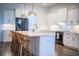 The kitchen island has marble countertops, white cabinets, and stainless steel appliances at 3176 Pearly Dr, Lakeland, FL 33812
