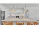 Bright, modern kitchen featuring a marble island, stainless steel appliances, and stylish pendant lighting at 3176 Pearly Dr, Lakeland, FL 33812