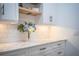 Bright kitchen featuring white cabinets, marble countertops and stylish subway tile backsplash at 3176 Pearly Dr, Lakeland, FL 33812