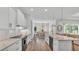 Open kitchen and dining area with island seating and stainless steel dishwasher and sink at 3176 Pearly Dr, Lakeland, FL 33812