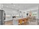 Bright open kitchen features white cabinets, marble countertops, island seating, and an adjacent dining area at 3176 Pearly Dr, Lakeland, FL 33812