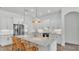 Elegant kitchen with a large marble island, stainless steel refrigerator, and pendant lights at 3176 Pearly Dr, Lakeland, FL 33812