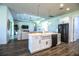 This kitchen features an island with a sink, stainless steel appliances, and modern lighting at 3176 Pearly Dr, Lakeland, FL 33812