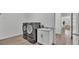 Modern laundry room with front loading washer and dryer and a utility sink with storage at 3176 Pearly Dr, Lakeland, FL 33812