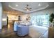 Bright living room boasts wood floors, a ceiling fan, and sliding glass doors to a screened patio at 3176 Pearly Dr, Lakeland, FL 33812
