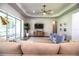 This living room showcases wood floors, modern decor, and access to a screened-in lanai at 3176 Pearly Dr, Lakeland, FL 33812