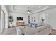 Bright, open living room with light wood floors, a trey ceiling, and view into the hall at 3176 Pearly Dr, Lakeland, FL 33812