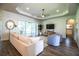 Relax in this living room featuring wood floors, recessed lighting, and access to the screened in lanai at 3176 Pearly Dr, Lakeland, FL 33812