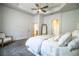 Elegant main bedroom with tray ceiling, ceiling fan, and doorway to ensuite bath at 3176 Pearly Dr, Lakeland, FL 33812